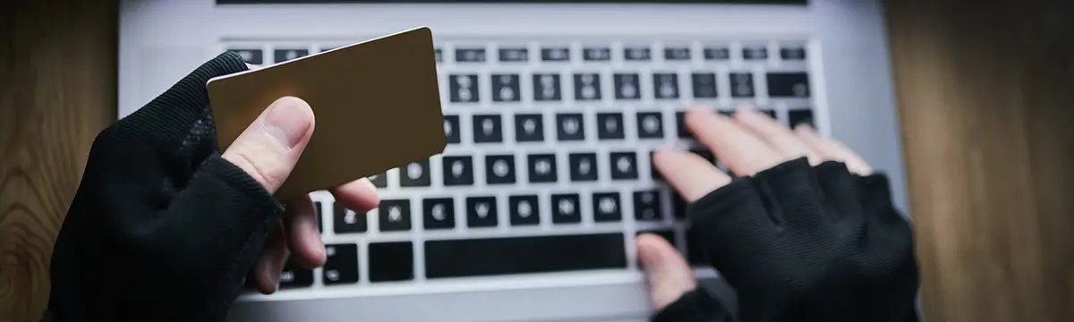laptop credit card hands hacker cyber crime financial fraud cloning identity theft breach person dark online hacking malware attack phishing account takeover